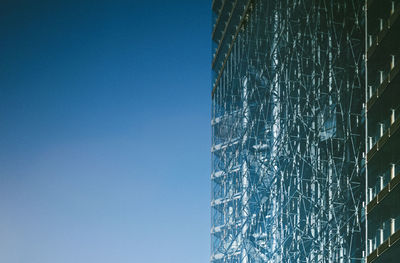 Low angle view of modern building against clear blue sky