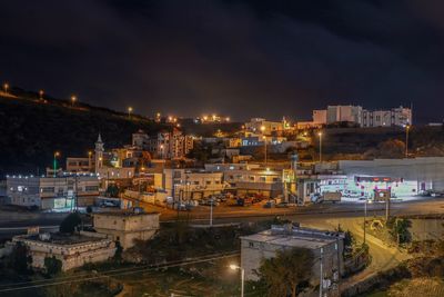 High angle view of illuminated buildings in city at night