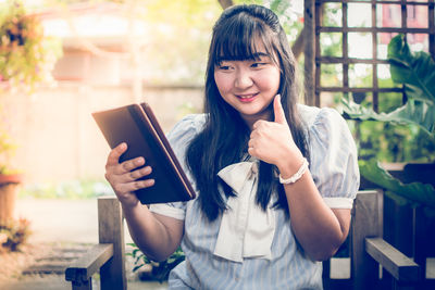Young woman holding mobile phone