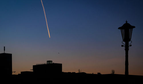 Low angle view of silhouette buildings against clear sky