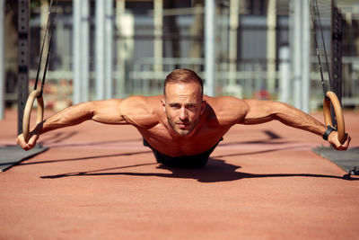 Low angle view of young man exercising in park