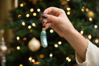 Close-up of woman hand holding christmas ornament