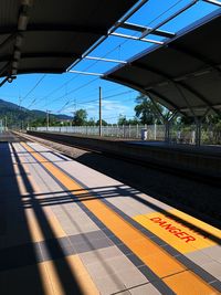 Railroad station platform against blue sky