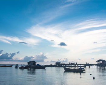 Boats moored in sea against sky