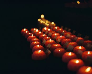 Illuminated tea light candles at night