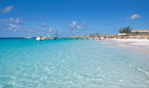 Scenic view of beach against blue sky