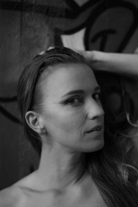Close-up portrait of young woman looking away