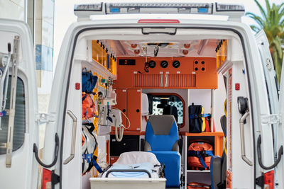 Interior of contemporary ambulance car equipped with various professional instruments and medical stretcher