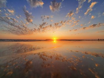 Scenic view of beach against sky during sunset