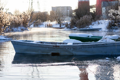 Frozen river in city during winter