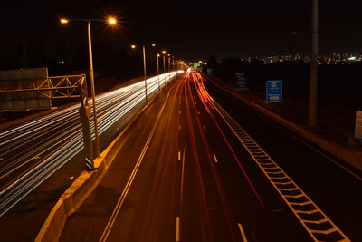 High angle view of light trails on highway at night