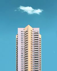 Low angle view of modern buildings against blue sky