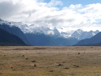 Scenic view of mountains against cloudy sky