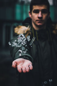 Portrait of young man holding camera