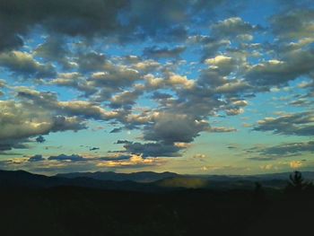 Scenic view of mountains against cloudy sky