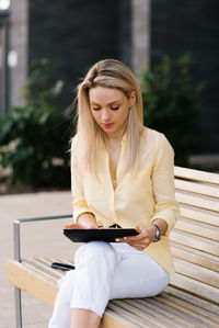 Happy woman using a tablet outdoors