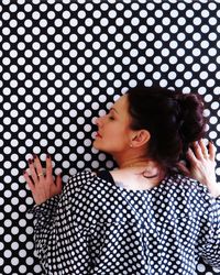 Woman hugging patterned wall