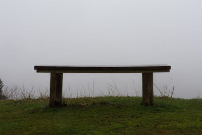 Pier on grass against sky