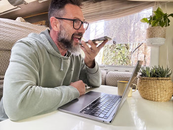 Young man using laptop at home