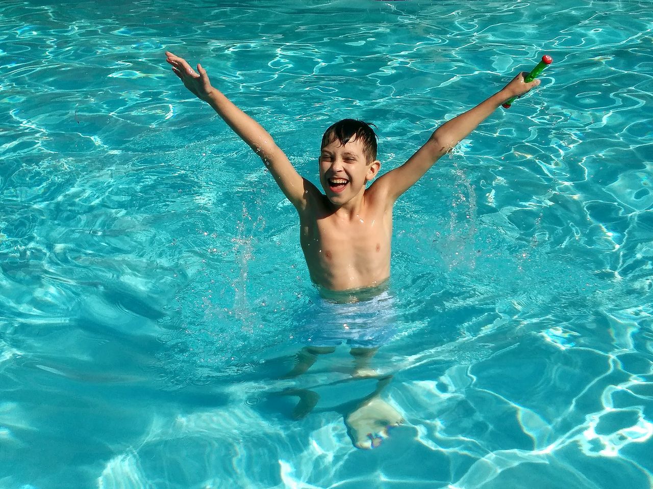 swimming pool, water, smiling, high angle view, happiness, one person, day, leisure activity, enjoyment, fun, young adult, outdoors, real people, rippled, floating on water, vacations, childhood, cheerful, swimming, young women, portrait, people