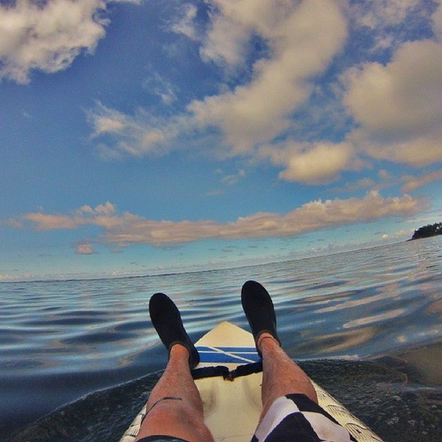 low section, person, water, personal perspective, shoe, sea, beach, sky, human foot, shore, tranquility, beauty in nature, scenics, cloud - sky, nature, part of, lifestyles