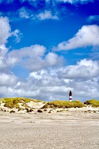 Man standing on land against blue sky