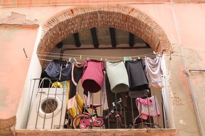 Clothes drying against wall in building