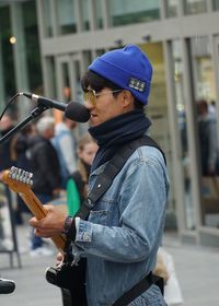 Rear view of man holding guitar