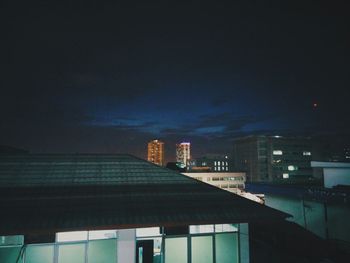 Low angle view of buildings against sky at night