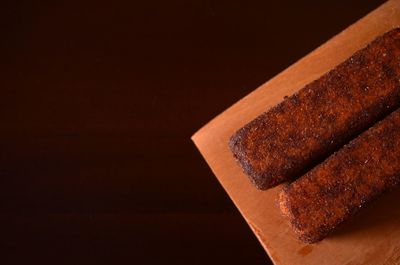 Close-up of chocolate cake on table against black background