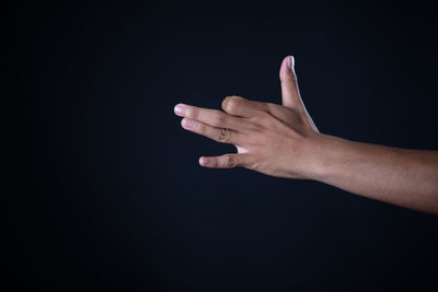 Midsection of person hand against black background