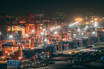 Illuminated cityscape against sky at night