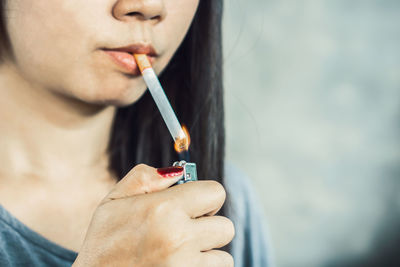 Close-up of woman hand holding cigarette