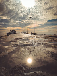 Street against sky during sunset