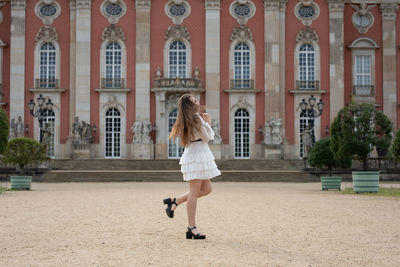 Rear view of woman against building