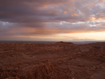 Scenic view of desert against sky during sunset