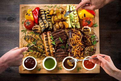 A board with grilled appetizers and sauces. grilled vegetables and meat snacks and sausages