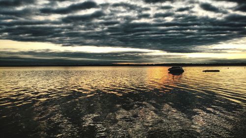 Scenic view of sea against dramatic sky