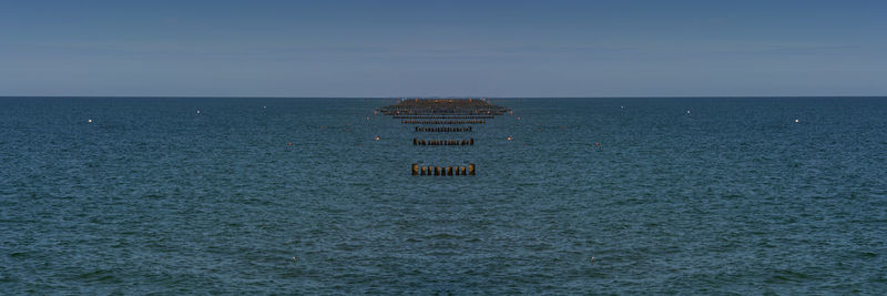 Scenic view of sea against clear blue sky