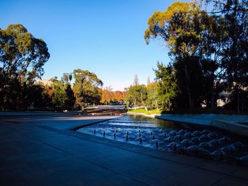 Swimming pool against clear blue sky