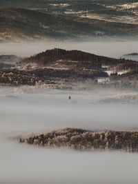 Scenic view of valley in fog