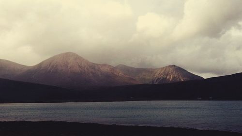 Scenic view of lake against cloudy sky