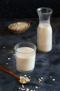 High angle view of oat flake with milk against black background