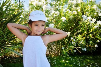 Portrait of smiling woman standing against plants