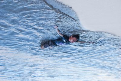 High angle view of man swimming in sea