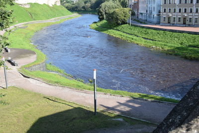 High angle view of river amidst trees in city