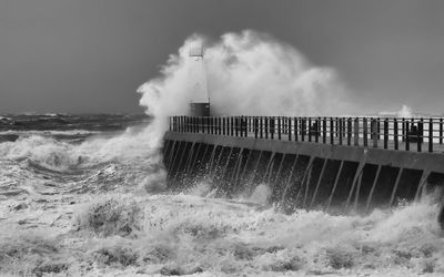 View of waves breaking against the sky
