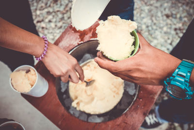 High angle view of hand holding ice cream