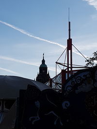 Low angle view of cross on building against sky