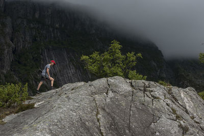 Rear view of man climbing on mountain